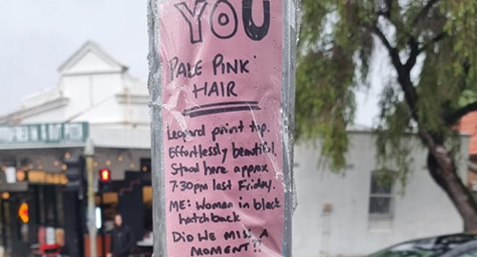 The roadside note was written on pink paper and is taped onto a lamppost outside a local business. 