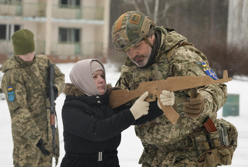 An instructor trains Rumia, 59, a member of Ukraine's Territorial Defense Forces, close to Kyiv, Ukraine, Saturday, Feb. 5, 2022. Hundreds of civilians have been joining Ukraine's army reserves in recent weeks amid fears about a Russian invasion. (AP Photo/Efrem Lukatsky)