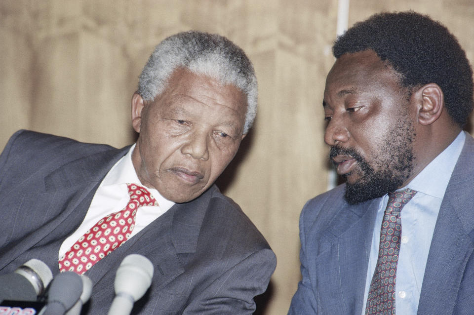 FILE — Then African National Congress President Nelson Mandela, left, and secretary general Cyril Ramaphose, now South African President, right, at a news conference in Johannesburg Monday, August 30, 1993. On Saturday, April 27, 2024 the country will celebrate Freedom day when In 1994 people braved long queues to cast votes after years of white minority rule which denied Black South Africans the right to vote. (AP Photo/Denis Farrell/File)