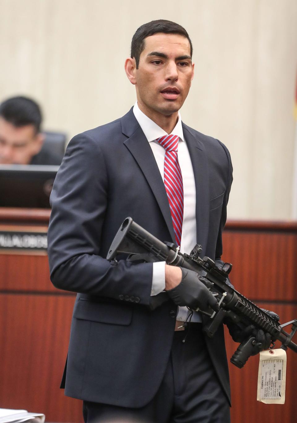 Prosecuting attorney Manny Busatamante holds the gun used to kill officers Palm Springs officers Zerebny and Vega during closing arguments during John Felix's trial at the Larson Justice Center in Indio, May 16, 2019.