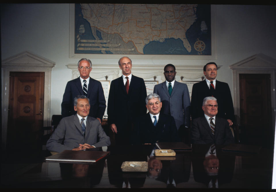 (Original Caption) Washington: Members of the Board of Governors of the Federal Reserve System pose for the first time since Arthur Burns replaced Wm. McC Martin as chairman. Groupings are as follows: Foreground: Chairman Arthur Burns; background (l to r): J.L. Robertson, vice chairman; Sherman J. Maisel; J. Dewey Daane; Andrew F. Brimmer; George Mitchell; and Mitchell W. Sherrill.