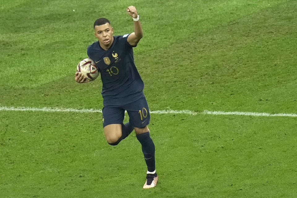 France's Kylian Mbappe celebrates his side's first goal during the World Cup final soccer match between Argentina and France at the Lusail Stadium in Lusail, Qatar, Sunday, Dec. 18, 2022. (AP Photo/Christophe Ena)