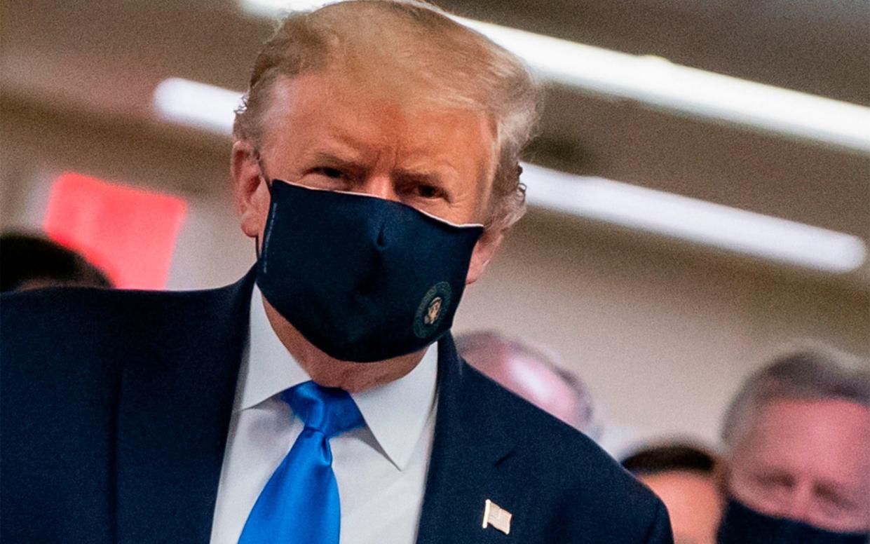 US President Donald Trump wears a mask as he visits Walter Reed National Military Medical Centre in Bethesda, Maryland - ALEX EDELMAN/AFP