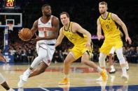 Jan 11, 2019; New York, NY, USA; New York Knicks guard Emmanuel Mudiay (1) drives to the basket against Indiana Pacers forward Bojan Bogdanovic (44) and forward Domantas Sabonis (11) during the third quarter at Madison Square Garden. Mandatory Credit: Brad Penner-USA TODAY Sports