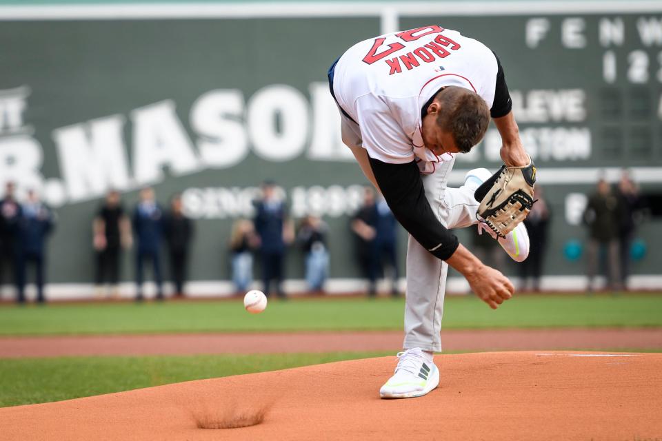 BOSTON, MASSACHUSETTS - APRIL 15: Rob Gronkowski, former NFL player for the New England Patriots spikes the ball on the mound for a ceremonial first pitch before a game between the Boston Red Sox and the Cleveland Guardians at Fenway Park on April 15, 2024 in Boston, Massachusetts. (Photo by Jaiden Tripi/Getty Images)