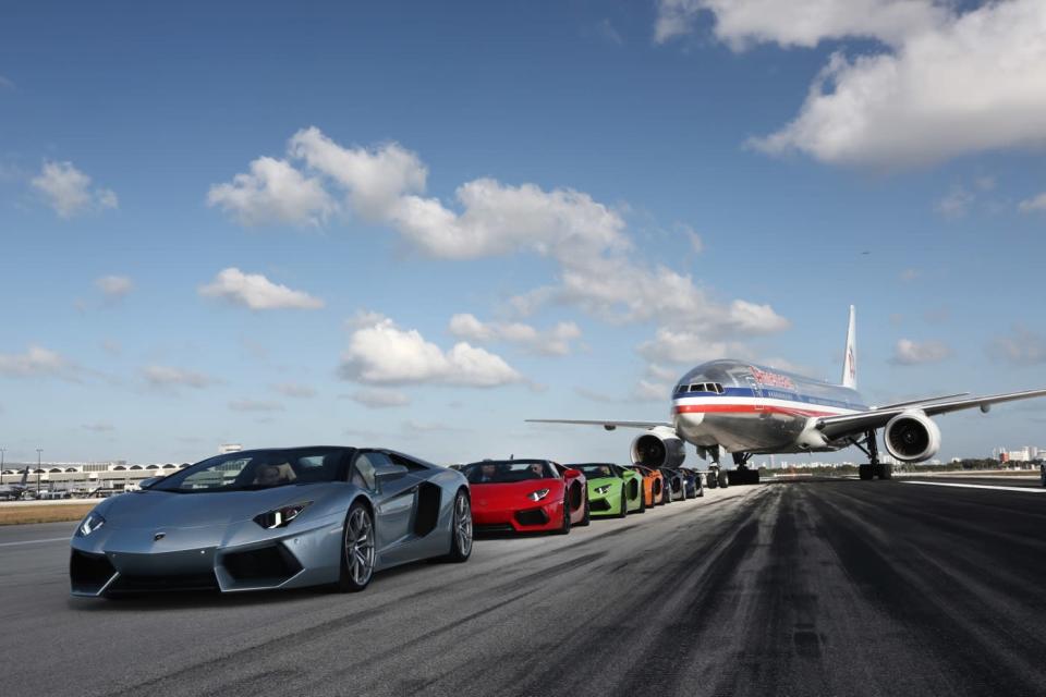 Lamborghini Aventador Roadsters race on the tarmac at Miami airport.