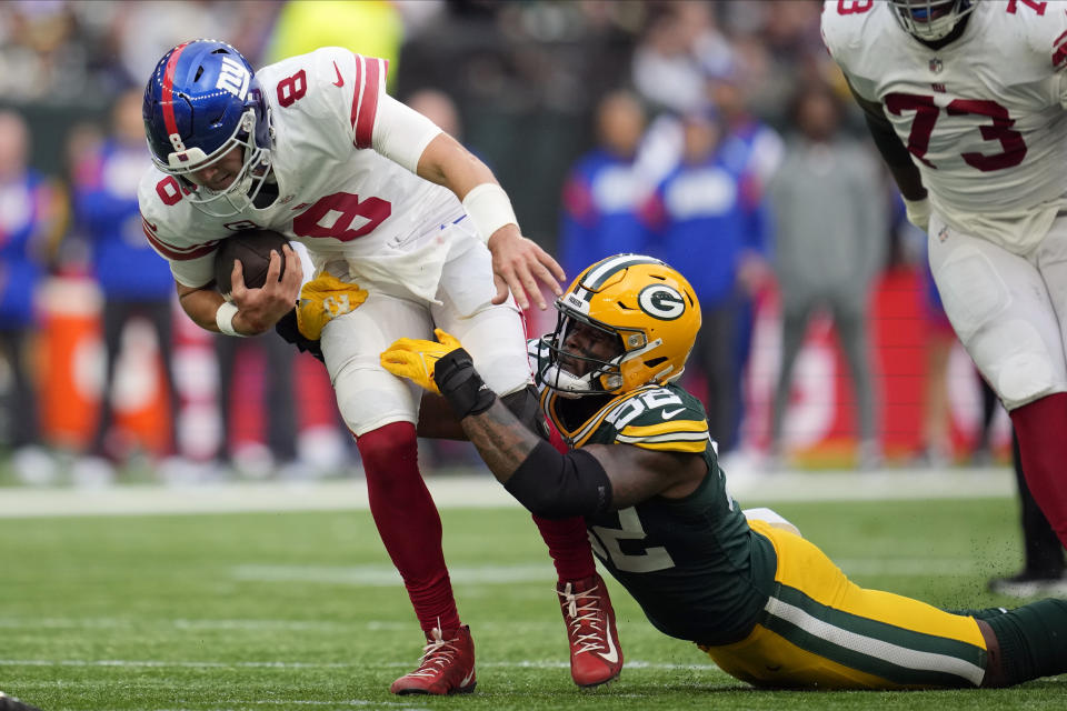 Green Bay Packers linebacker Rashan Gary (52) tackles New York Giants quarterback Daniel Jones (8) during the second half of an NFL football game at the Tottenham Hotspur stadium in London, Sunday, Oct. 9, 2022. (AP Photo/Kin Cheung)