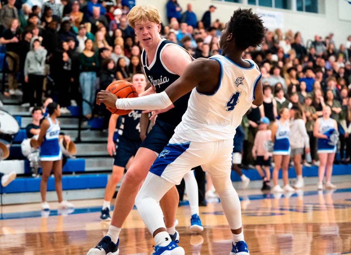 Olympia’s forward Andreas Engholm (2) shoves Curtis’s forward Josiah Johnson (4) while driving to the basket during a basketball game at Curtis High School in University Place, Wash. on Jan. 7, 2023. Olympia defeated Curtis 72-60.