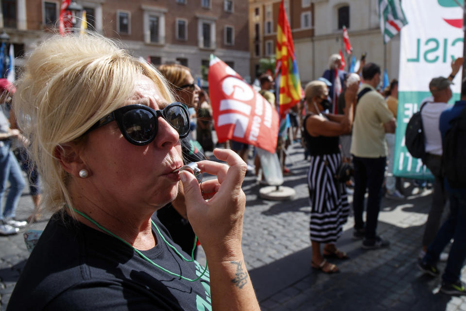 Alitalia workers stage a protest in Rome, Tuesday, Sept. 21, 2021. Italy’s failing national carrier Alitalia told passengers on Tuesday to just bring a single piece of hand luggage when travelling, given intensifying strikes and labor protests are disrupting service ahead of the airline’s Oct. 14 demise. In a series of Tweets, Alitalia apologized to its customers and blamed the disruptions on union meetings that “over the coming days could result in delays in the services provided by Alitalia.” (Roberto Monaldo/LaPresse via AP)