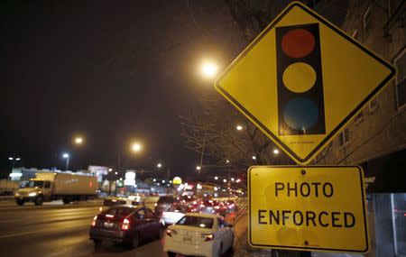 Cars approach an intersection where a red light camera is placed in Chicago, Illinois, February 9, 2015. REUTERS/Jim Young