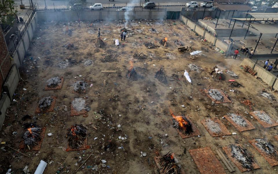 Multiple funeral pyres of victims of burn in a ground that has been converted into a crematorium for mass cremation.  - AP