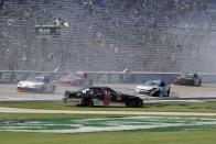 Matt Mills (5) and Jeb Burton (10) crash along the front stretch during a NASCAR Xfinity Series auto race at Texas Motor Speedway in Fort Worth, Texas, Saturday, June 12, 2021. (AP Photo/Larry Papke)