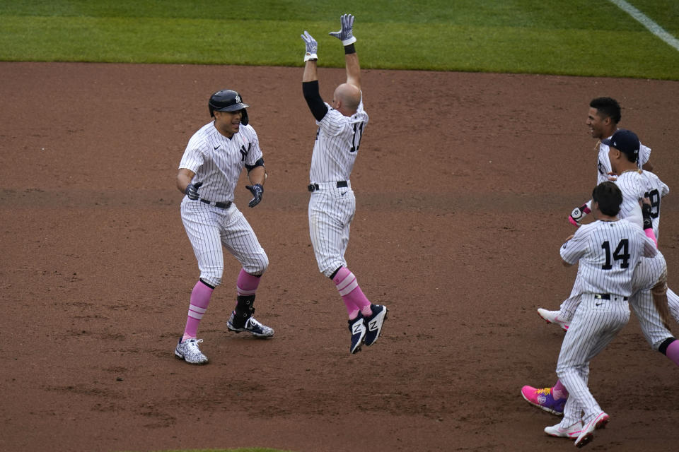 New York Yankees' Giancarlo Stanton, left, celebrates his walkoff single with teammates during the ninth inning of a baseball game against the Washington Nationals at Yankee Stadium, Sunday, May 9, 2021, in New York. (AP Photo/Seth Wenig)