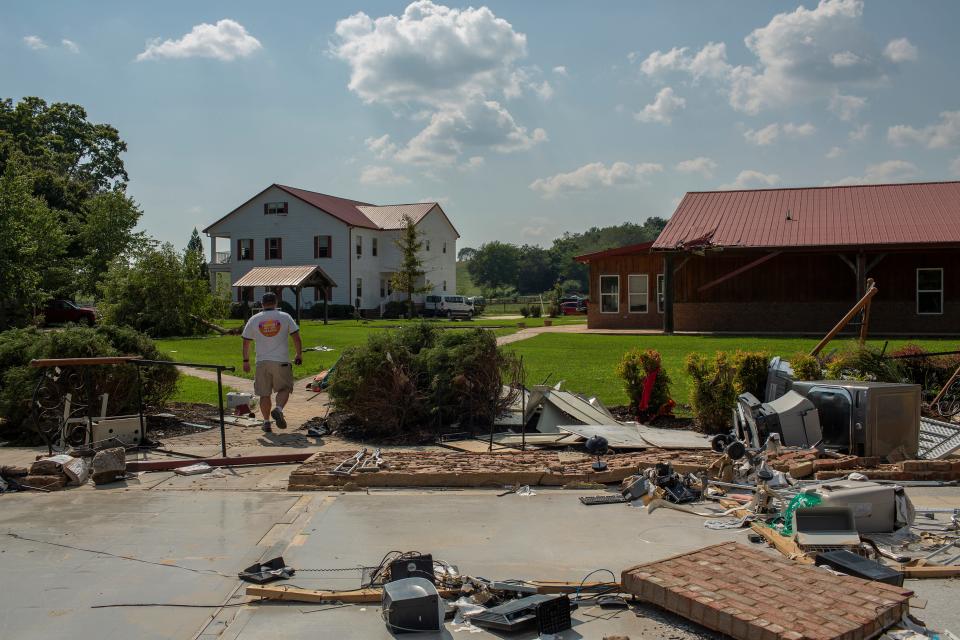 The Ranch Tennessee staff member Joel Wilkerson walks the grounds of the mental health and addiction recovery center while managing recovery efforts at the center located near Nunnelly, Tenn., on Tuesday, Aug. 24, 2021.