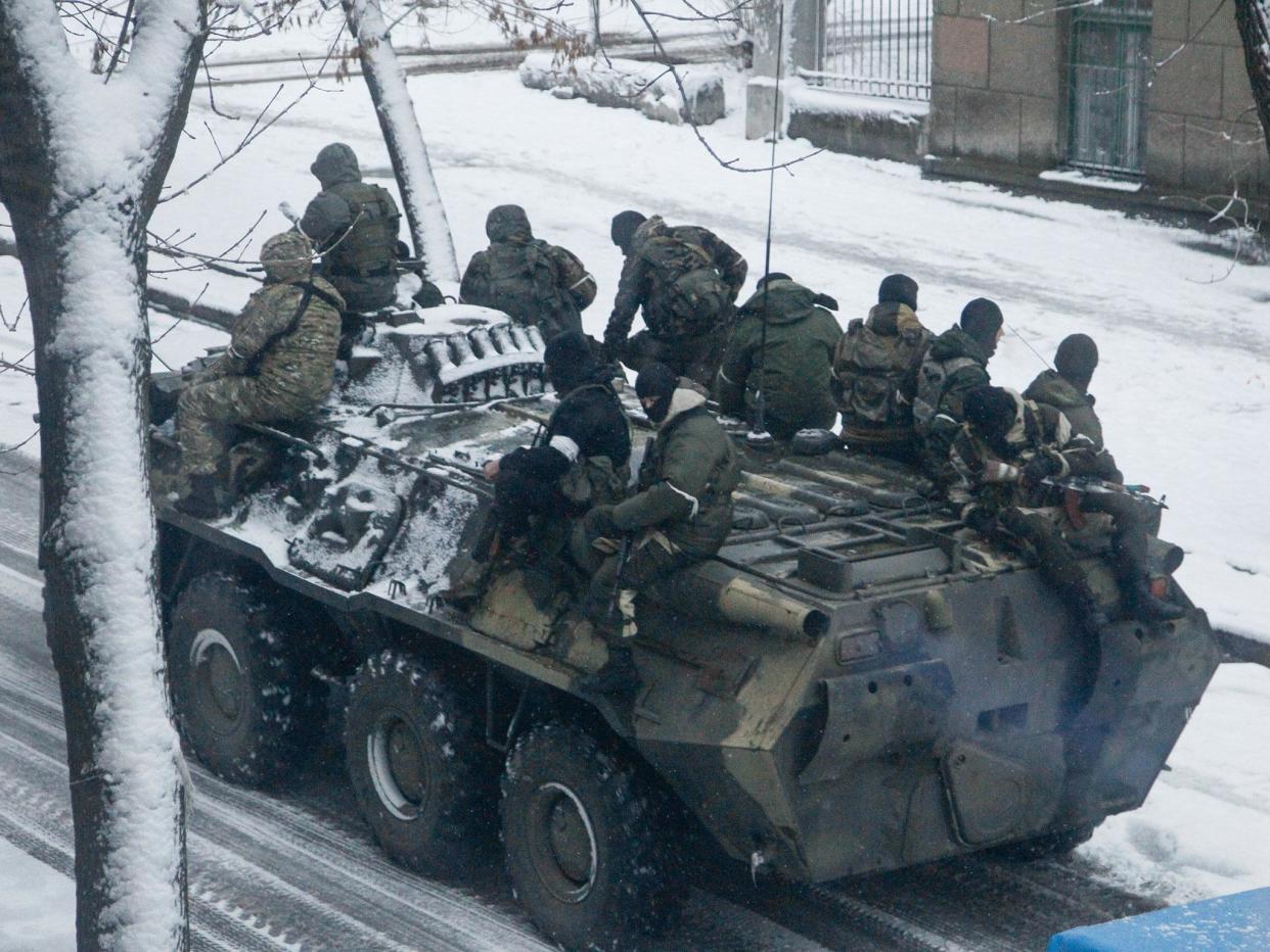 Armed men without insignia ride on a personnel carrier along a street in Luhansk city, Ukraine, on 23 November 2017: EPA