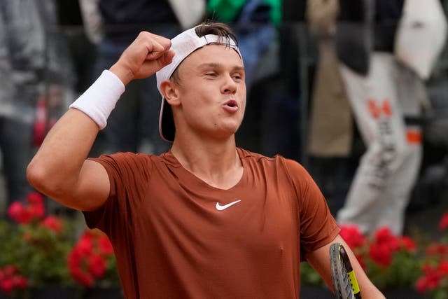 Holger Rune celebrates beating Novak Djokovic in Rome