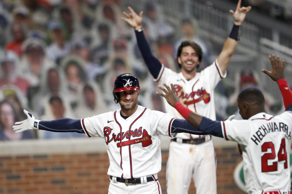 Atlanta Braves' Nick Markakis, left, celebrates with Adeiny Hechavarria (24) after hitting a game-winning home run in the ninth inning of a baseball game against the Atlanta Braves Thursday, Aug. 6, 2020, in Atlanta. (AP Photo/John Bazemore)