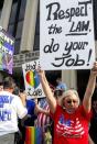 Lana Bailey holds a placard on the steps of the federal building in protest of Rowan County clerk Kim Davis' arrival to attend a contempt of court hearing for her refusal to issue marriage certificates to same-sex couples, at the United States District Court in Ashland, Kentucky September 3, 2015. REUTERS/Chris Tilley