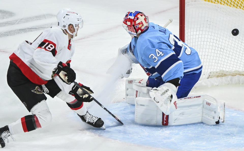 Ottawa Senators' Tim Stutzle (18) scores against Montreal Canadiens goaltender Jake Allen during the first period of an NHL hockey game, Tuesday, Jan. 31, 2023 in Montreal. (Graham Hughes/The Canadian Press via AP)