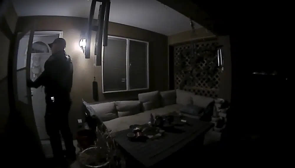 In this image taken from body camera video provided by the Farmington Police Department, a police officer knocks on the door of the wrong address in response to a domestic violence call, in Farmington, N.M., late April 5, 2023. (Farmington Police Department via AP)