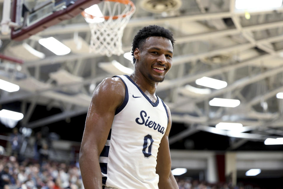 FILE - Sierra Canyon's Bronny James smiles during a high school basketball game against Christopher Columbus at the Hoophall Classic, Jan. 16, 2023, in Springfield, Mass. On Wednesday, Oct. 11, 2023, Southern California basketball coach Andy Enfield said James, the oldest son of NBA superstar LeBron James, is “doing well” nearly three months after the prized recruit went into cardiac arrest while participating in a practice on campus. (AP Photo/Gregory Payan, File)