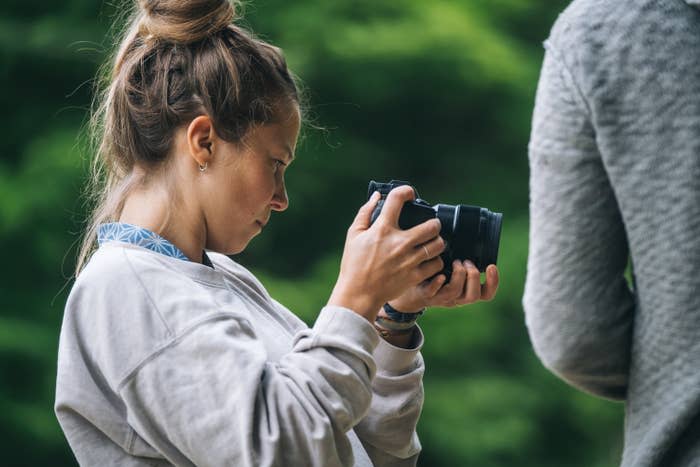 A photographer looking at her camera