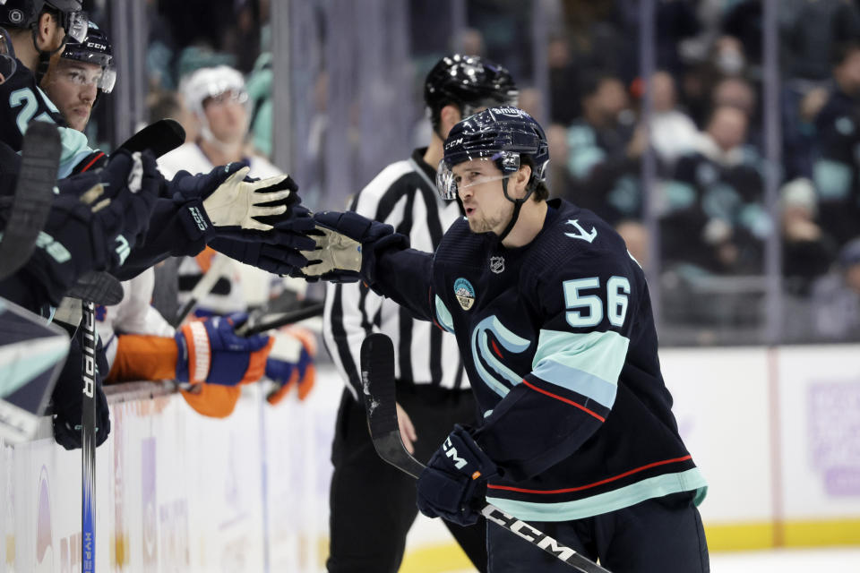 Seattle Kraken right wing Kailer Yamamoto (56) is congratulated after scoring in the shootout against the New York Islanders in an NHL hockey game Thursday, Nov. 16, 2023, in Seattle. (AP Photo/John Froschauer)