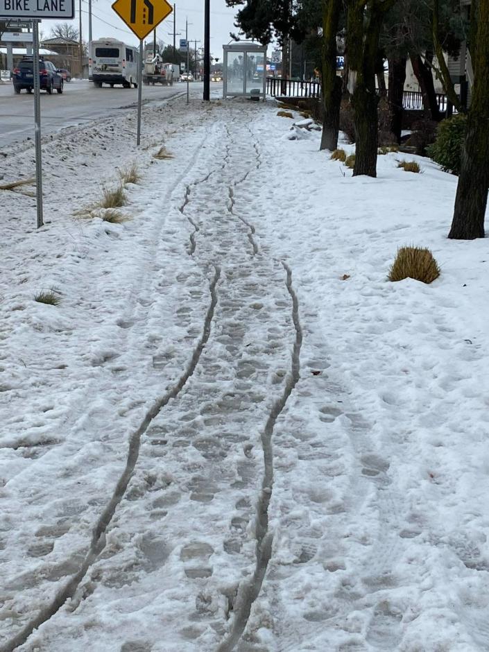 Tracks left by the man David Hess saw struggling to push his wheelchair across the snow.