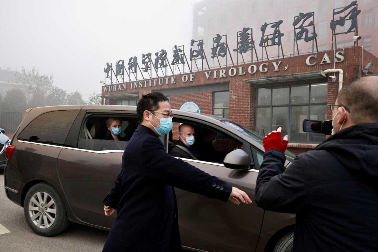 Peter Daszak and Thea Fischer, members of the World Health Organization (WHO) team tasked with investigating the origins of the coronavirus disease (COVID-19), sit in a car arriving at Wuhan Institute of Virology in Wuhan, Hubei province, China February 3, 2021. REUTERS/Thomas Peter     TPX IMAGES OF THE DAY