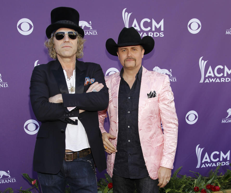 FILE - This April 1, 1012 file photo shows Big Kenny, left, John Rich, of musical group Big and Rich, arriving at the 47th Annual Academy of Country Music Awards in Las Vegas. After a five-year break, Big & Rich are putting the funny back in country music _ with the help of Jon Bon Jovi and Richie Sambora.The unlikely quartet gathered to write two songs for the country duo's new album "Hillbilly Jedi" after they struck up a friendship a few years back. (AP Photo/Isaac Brekken, file)