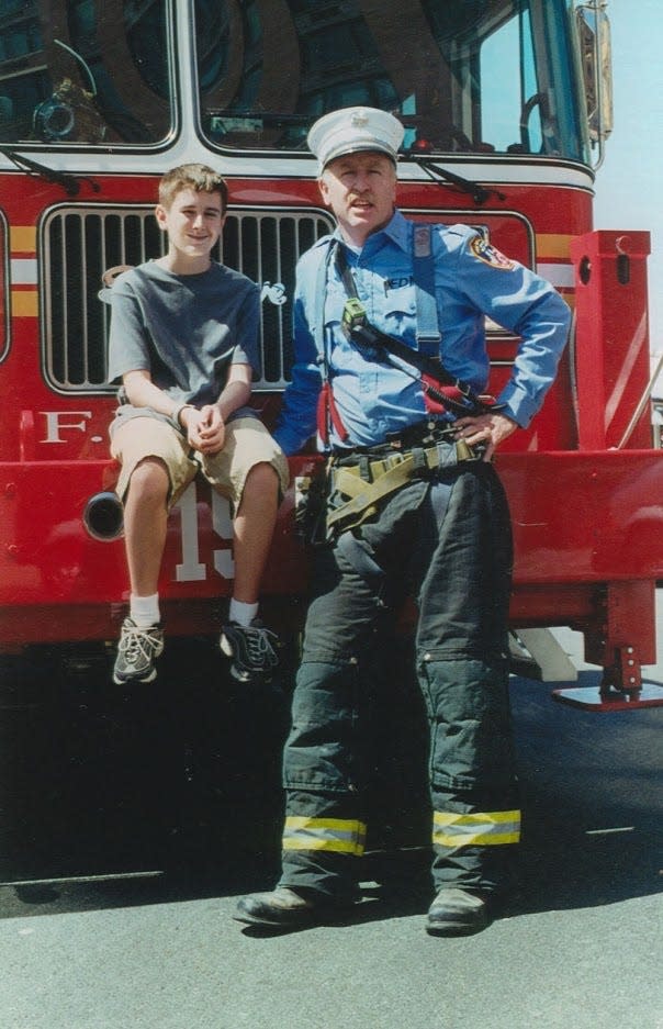 Brian with his father, Joseph Leavey, in front of Ladder 15 at the South Street Seaport in 1999 or 2000.