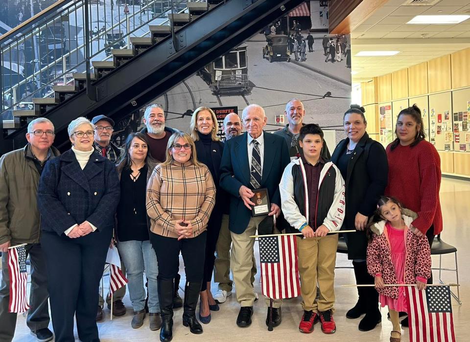 Specialist Fourth Class Charles Norman Gagnon, his family, and State Rep. Carole Fiola. Gagnon received the Vietnamese Cross of Gallantry at the Fall River Veterans Day Ceremony at B.M.C. Durfee High School, nearly 58 years after he was awarded the recognition.