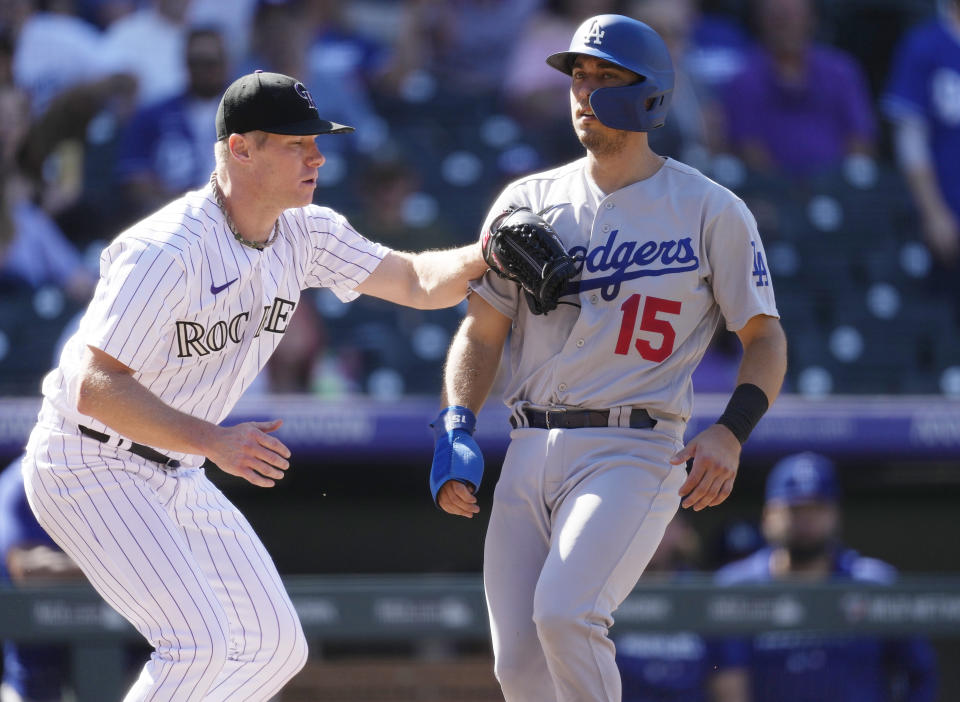 Colorado Rockies starting pitcher Chase Anderson, left, tags out Los Angeles Dodgers' Austin Barnes after he was caught in a rundown between third base and home plate while trying to advance on a single hit by Freddie Freeman in the fifth inning of the first game of a baseball doubleheader on Tuesday, Sept. 26, 2023, in Denver. (AP Photo/David Zalubowski)