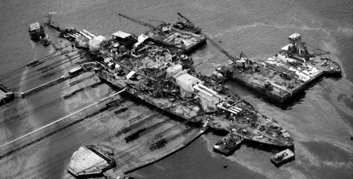 An aerial view of the ravaged USS Oklahoma in 1943 during a salvage operation in Pearl Harbor, Hawaii. By then the remains of the sailors had been recovered but not identified.