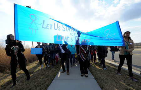 People march before a vigil for Srinivas Kuchibhotla, an Indian engineer who was shot and killed, at a conference center in Olathe, Kansas, U.S., February 26, 2017. REUTERS/Dave Kaup