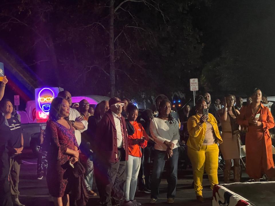 Actress Lynn Whitfield and director Spike Lee watch on as Sen. Raphael Warnock talks to the crowd at a rally on Sunday night.