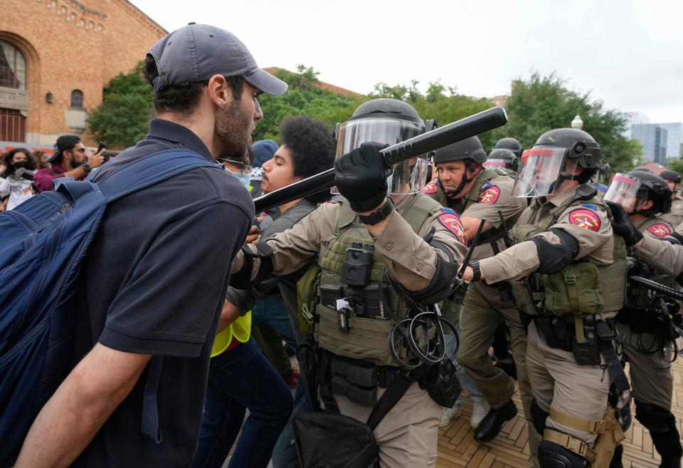 State troopers in riot gear try to break up a pro-Palestinian protest at the University of Texas Wednesday April 24, 2024.