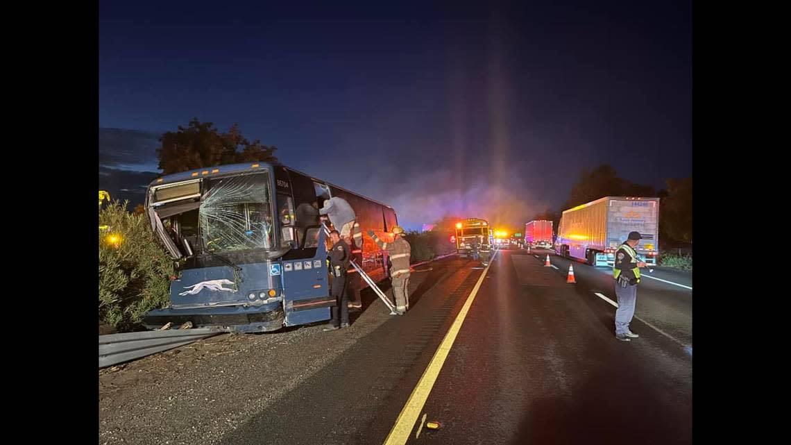 Tulare firefighters help riders off of a Greyhound bus that crashed on Highway 99 south of Highway 137 on Wednesday, Nov. 9, 2022, according to the California Highway Patrol. TULARE FIRE DEPARTMENT