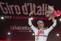 Tadej Pogačar celebrates on podium after winning stage 2 of the Giro d'Italia from San Francesco al Campo to Santuario di Oropa, Italy, Sunday, May 5, 2024. (Gian Mattia D'Alberto/LaPresse via AP)