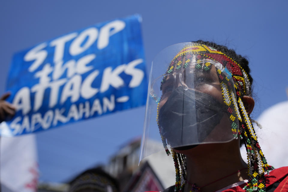 A protester wearing a traditional dress joins a rally outside the Malacanang palace in Manila, Philippines on Wednesday, June 30, 2021. The group has called for justice and accountability for the thousands who have died due to the government's anti-drug crackdown under the administration of Philippine President Rodrigo Duterte. (AP Photo/Aaron Favila)