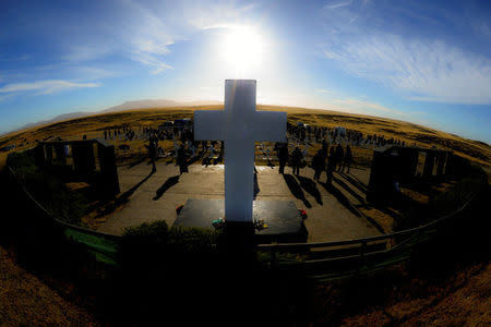 Relatives of Argentine soldiers who died during the Falklands War visit Darwin cemetery, where their relatives were buried, in the Falkland Islands, March 26, 2018. Argentine Presidency/Handout via REUTERS