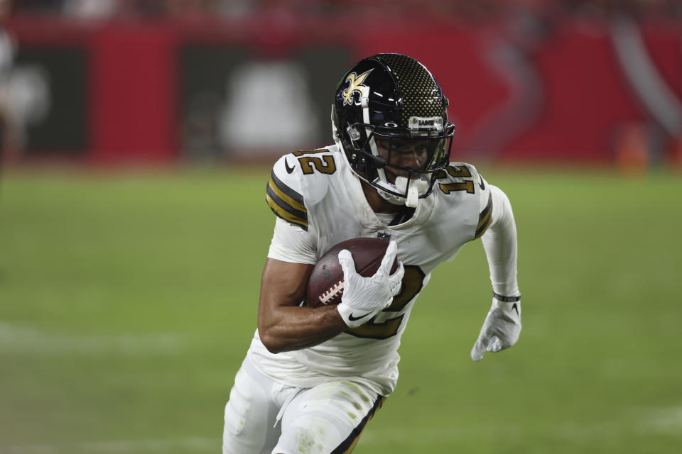 New Orleans Saints wide receiver Chris Olave (12) carries in the second half of an NFL football game against the Tampa Bay Buccaneers in Tampa, Fla., Monday, Dec. 5, 2022. (AP Photo/Mark LoMoglio)