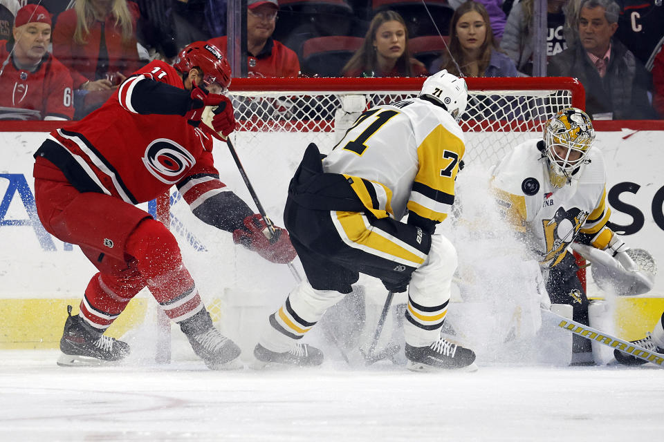 Carolina Hurricanes' Jordan Staal (11) shoots the puck past Pittsburgh Penguins' Evgeni Malkin (71), but has it blocked by goaltender Tristan Jarry (35) during the first period of an NHL hockey game in Raleigh, N.C., Saturday, Jan. 13, 2024. (AP Photo/Karl B DeBlaker)