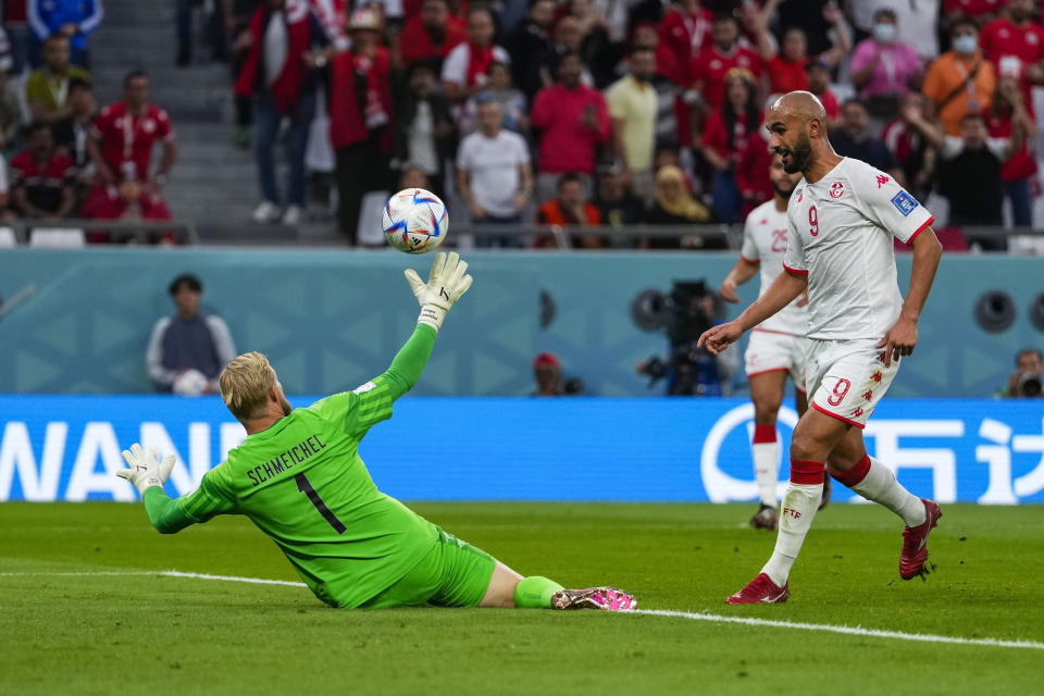 Tunisia's Issam Jebali, right, challenges Denmark's goalkeeper Kasper Schmeichel during the World Cup group D soccer match between Denmark and Tunisia, at the Education City Stadium in Al Rayyan, Qatar, Tuesday, Nov. 22, 2022. (AP Photo/Manu Fernandez)