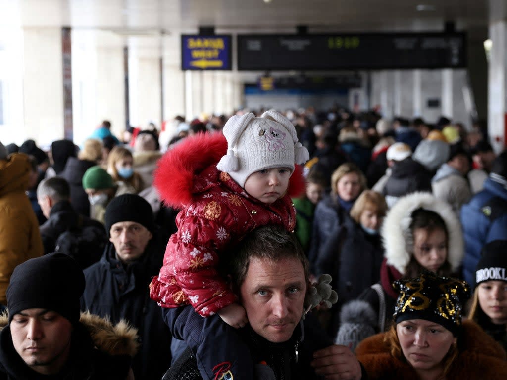 People wait to board an evacuation train from Kyiv to Lviv at Kyiv central train station following Russia's invasion of Ukraine (REUTERS)