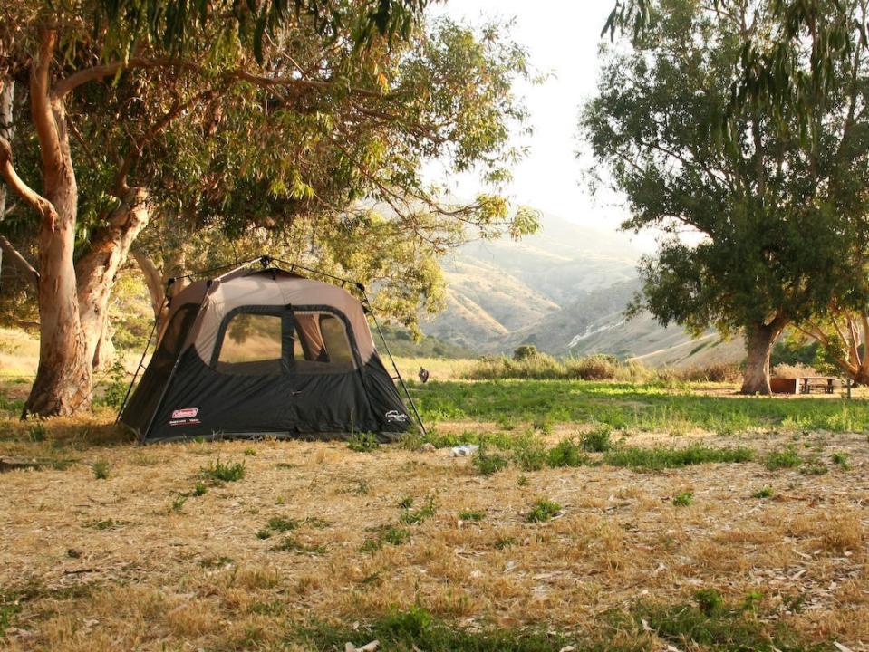 A tent in a field for camping.