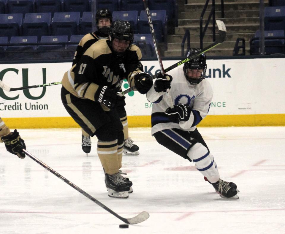 Oyster River's Nolan Walsh, right, and Trumbull's Ilario Muoio have their eyes on the puck during Thursday night's Heuchling & Swift Memorial Classic at the Whittemore Center.