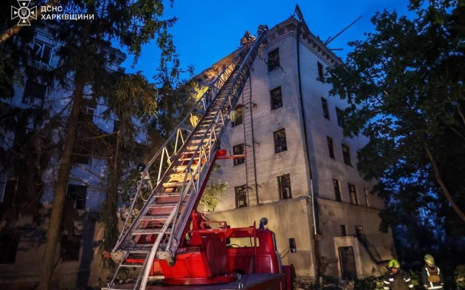 Fire fighters work on putting out the fire broke out after the Russian rocket attacks