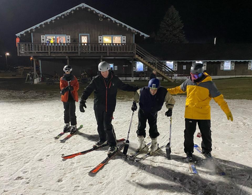 Special Outdoor Leisure Opportunities volunteers follow long-time participant Glen Swank as he uses his outrigger poles in winter 2023 at Swiss Valley Ski & Snowboard Area in Jones.