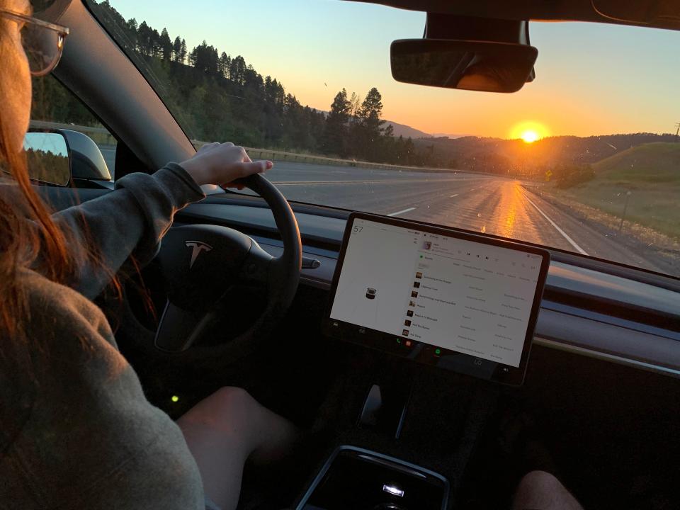 The author driving the Tesla on a highway in Montana.